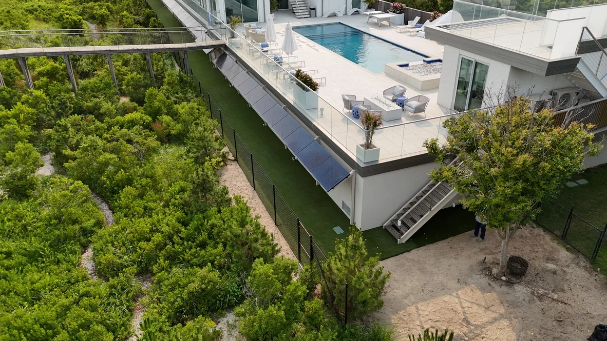 Turf lawn and paver pool deck kept clean on a waterfront property